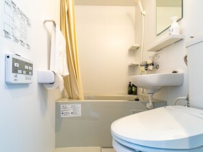 A bathroom with a toilet, sink, and shower. There is a control panel on the wall and a towel hanging on the door. - BANDE HOTEL TEMPOZAN (Osaka)