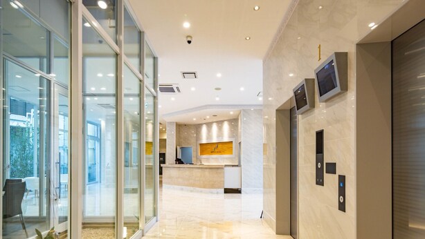 A modern hotel lobby with a glass entrance, a reception desk, and a marble floor. - BANDE HOTEL TEMPOZAN (Osaka)