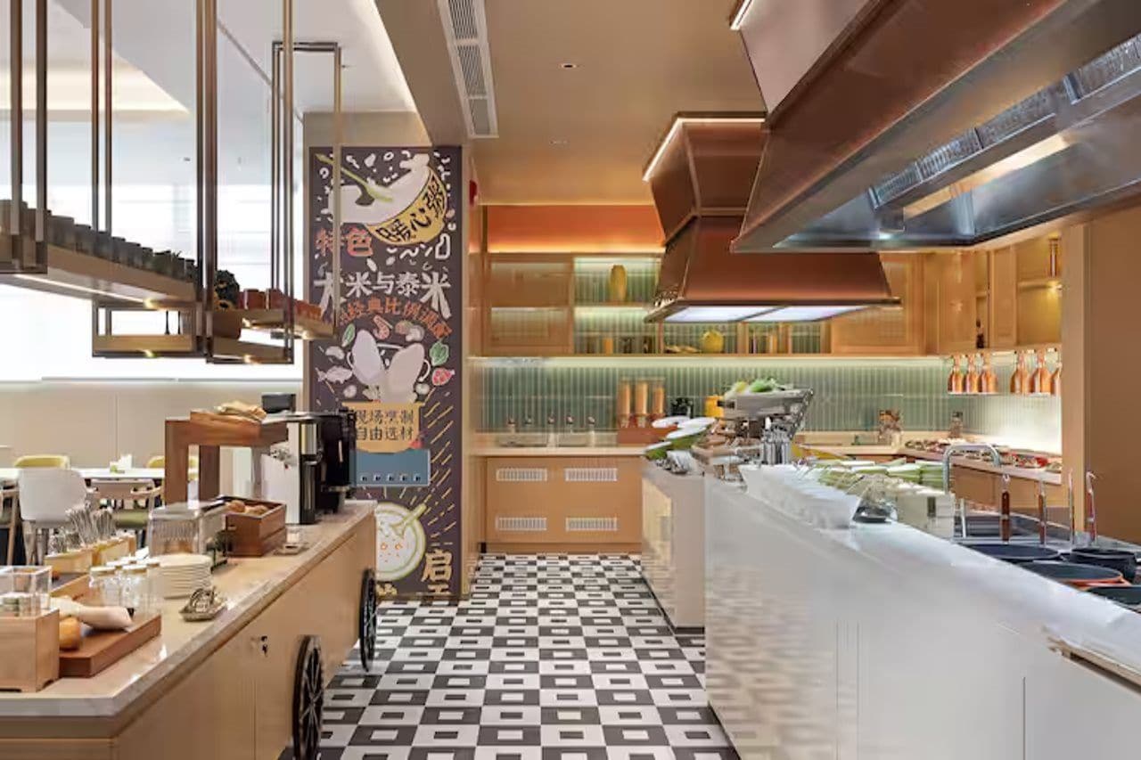A modern kitchen with a checkered floor, a central island, and a vertical banner with text.