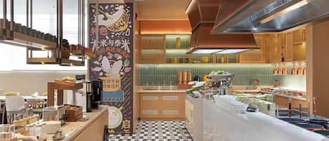 A modern kitchen with a checkered floor, a central island, and a vertical banner with text.