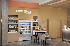 A store named HOME 2 MKT with a variety of snacks and beverages on shelves.