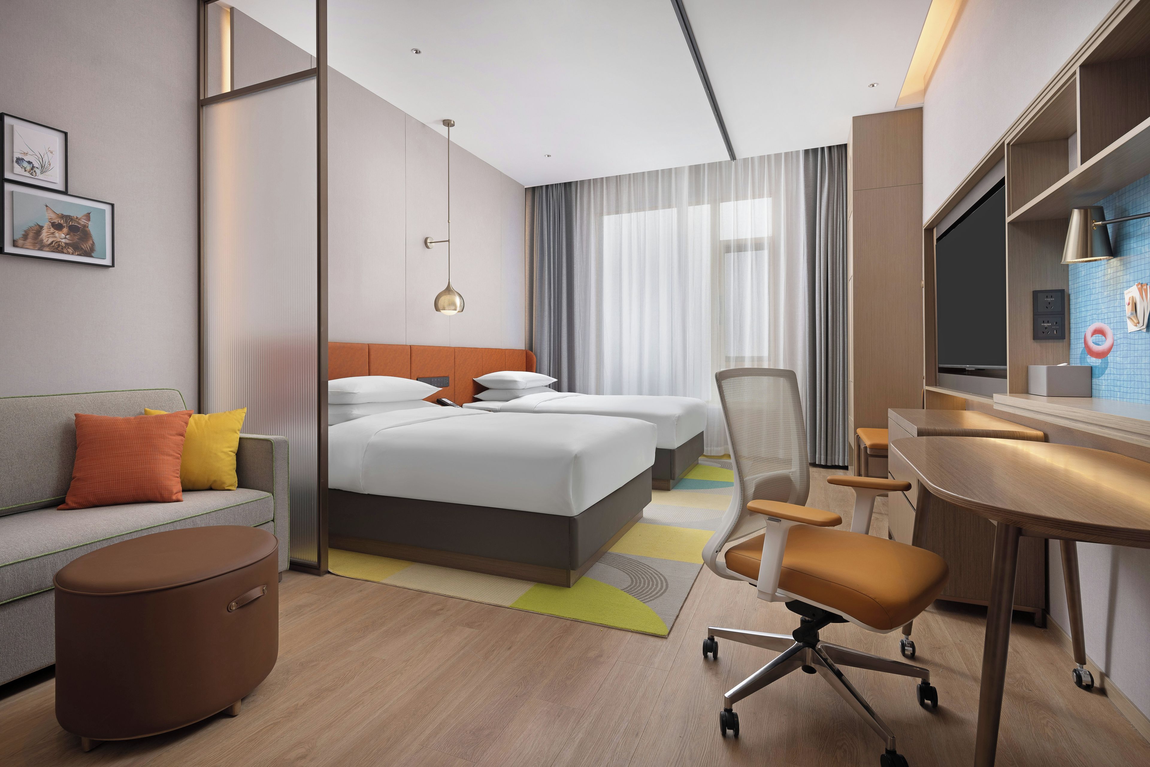 Een hotelkamer met een bed, een bureau, een stoel, een bank en een kleine tafel.