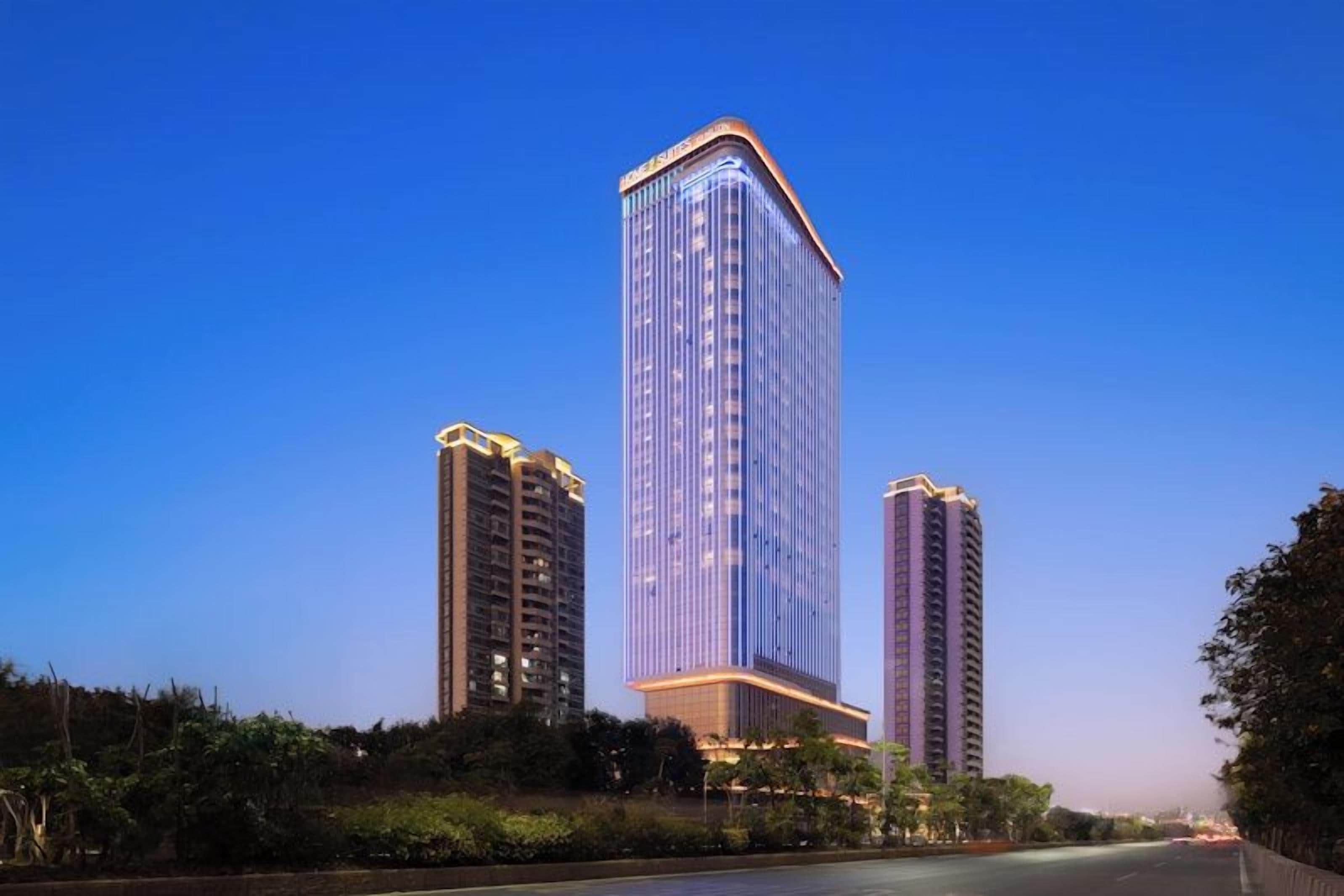 A high-rise building with a modern design, featuring a prominent glass facade and a flat roof.