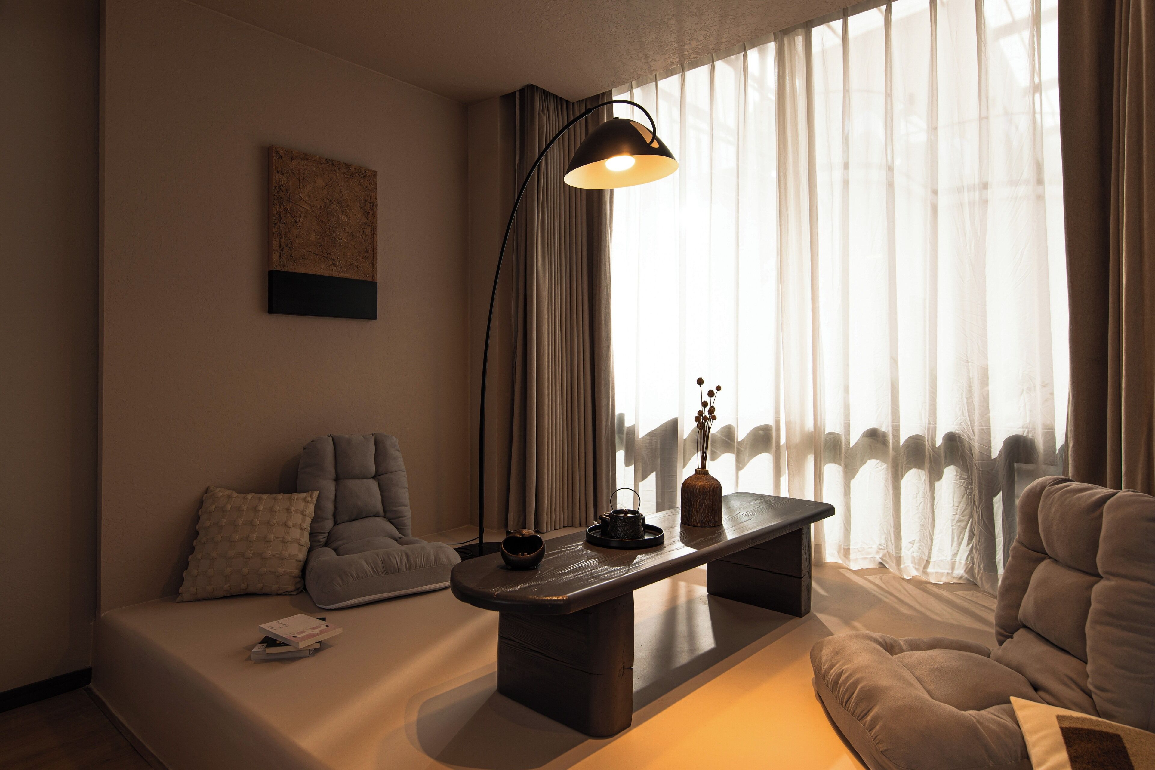 A modern living room with a sofa, a coffee table, and a lamp.