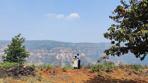 A person standing on a hill overlooking a mountainous landscape. - Eagle Eye Resort (Mahabaleshwar)