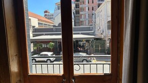 A wooden door with a view of a street and buildings, including a construction site. - Long Street Self Catering Apartments (Cape Town)