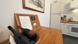 A corkboard with a framed painting, a bulletin board with a menu, and a wooden table with bottles and a menu. - L'Antico Palazzo - Mansion with Pool (TOANO)
