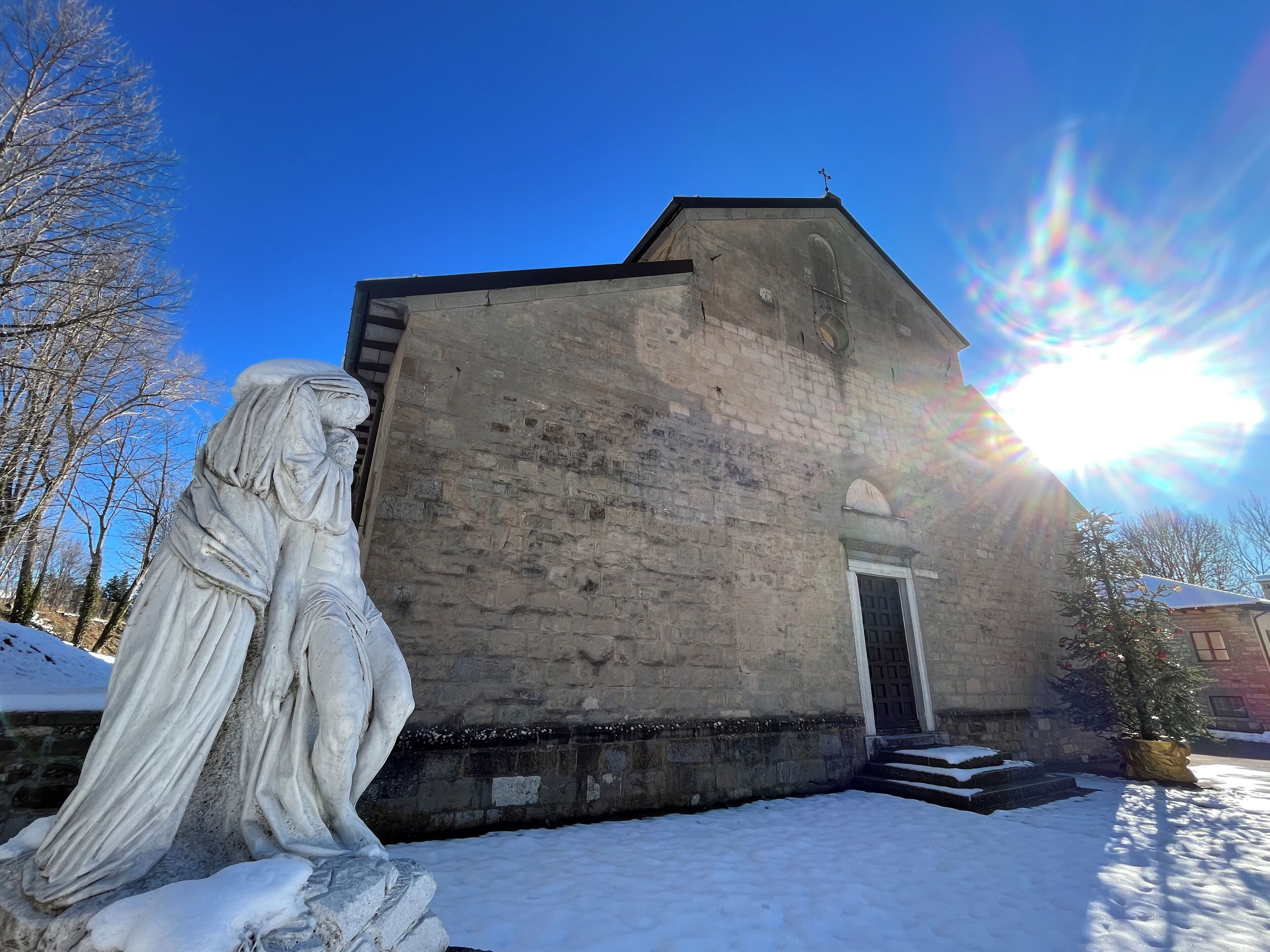 Un bâtiment en pierre avec une statue devant.