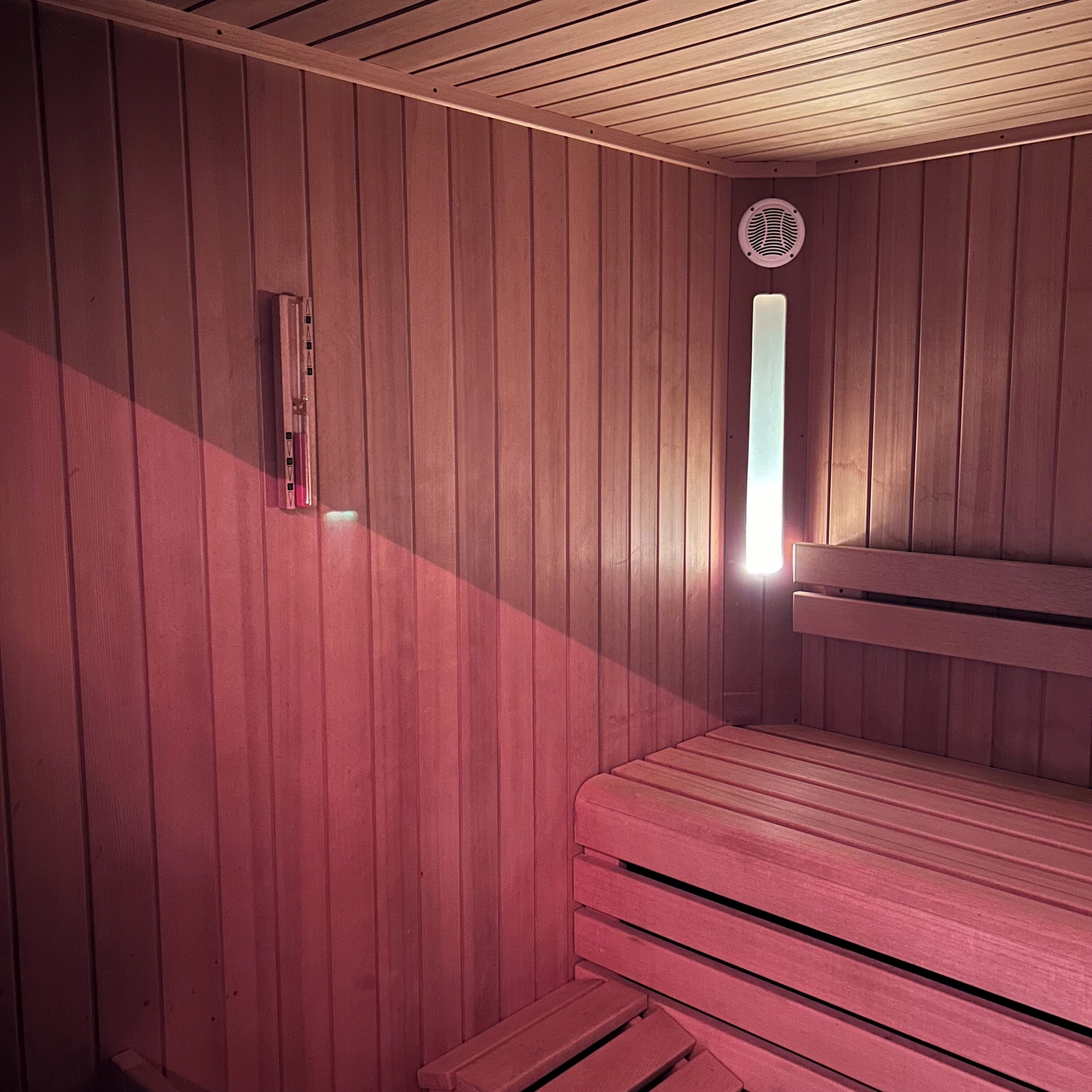 A sauna with wooden walls and benches.