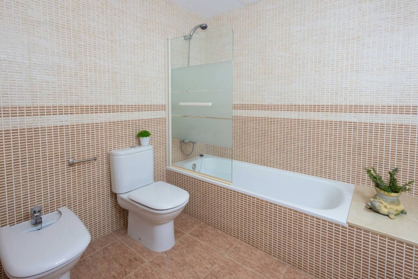 Un baño con inodoro, lavabo y bañera.