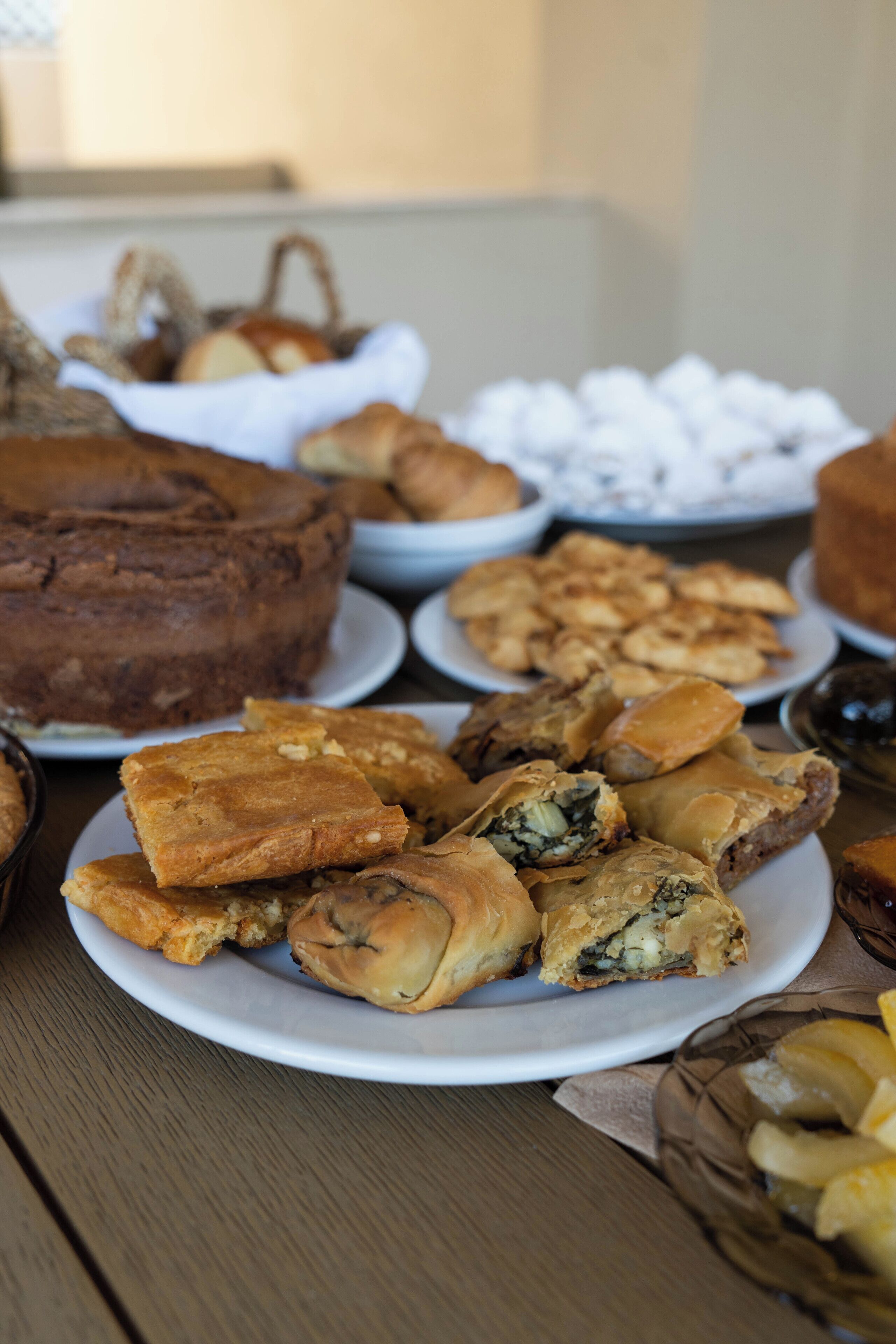 A table with various pastries and a cake.