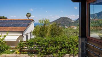 Un edificio con un tetto solare, vista su una montagna e cielo sereno.
