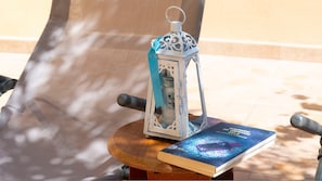 A wooden table with a book and a decorative lantern.