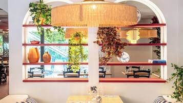 A restaurant with a wooden table, chairs, and a hanging light fixture.