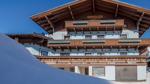 A multi-story building with a wooden facade and balconies, labeled "GANDOLER". - Chalet in Austria near Ski Slopes (Mittersill)