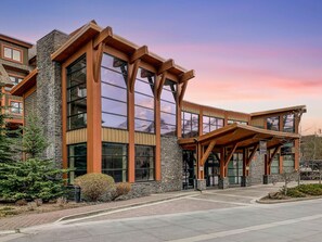 A modern building with large windows and a covered entrance. - Spacious Resort Condo | Near Banff (Canmore)