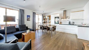 A modern apartment with a living area, dining space, and kitchen. - Apartment in Gerlos near Ski Lift (Gerlos)