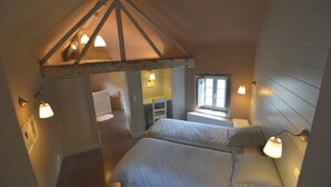 A cozy room with two beds, a wooden ceiling, and a window providing natural light. - Elegant Estate Stay, Maredsous (Maredsous)