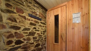 A stone wall with a wooden door and a coat rack. - Gouvy Forest Farmhouse (Gouvy)