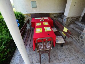 An outdoor dining area with red tablecloths and benches. - Outdoor Adventure & Relaxation (Svinařov Slabce)