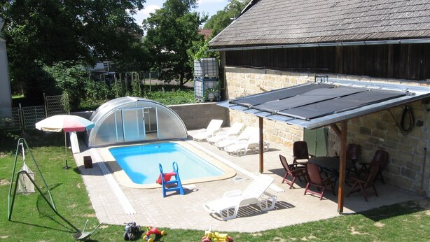 A backyard with a swimming pool, covered patio, and outdoor seating area. - Villa in Zelenecká Lhota with Private Pool (Liban)