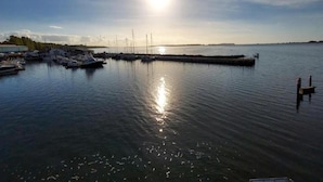 A marina with boats docked, calm water, and a clear sky. - Gemütlicher Aufenthalt am Wieker Hafen (Wiek auf Rügen)