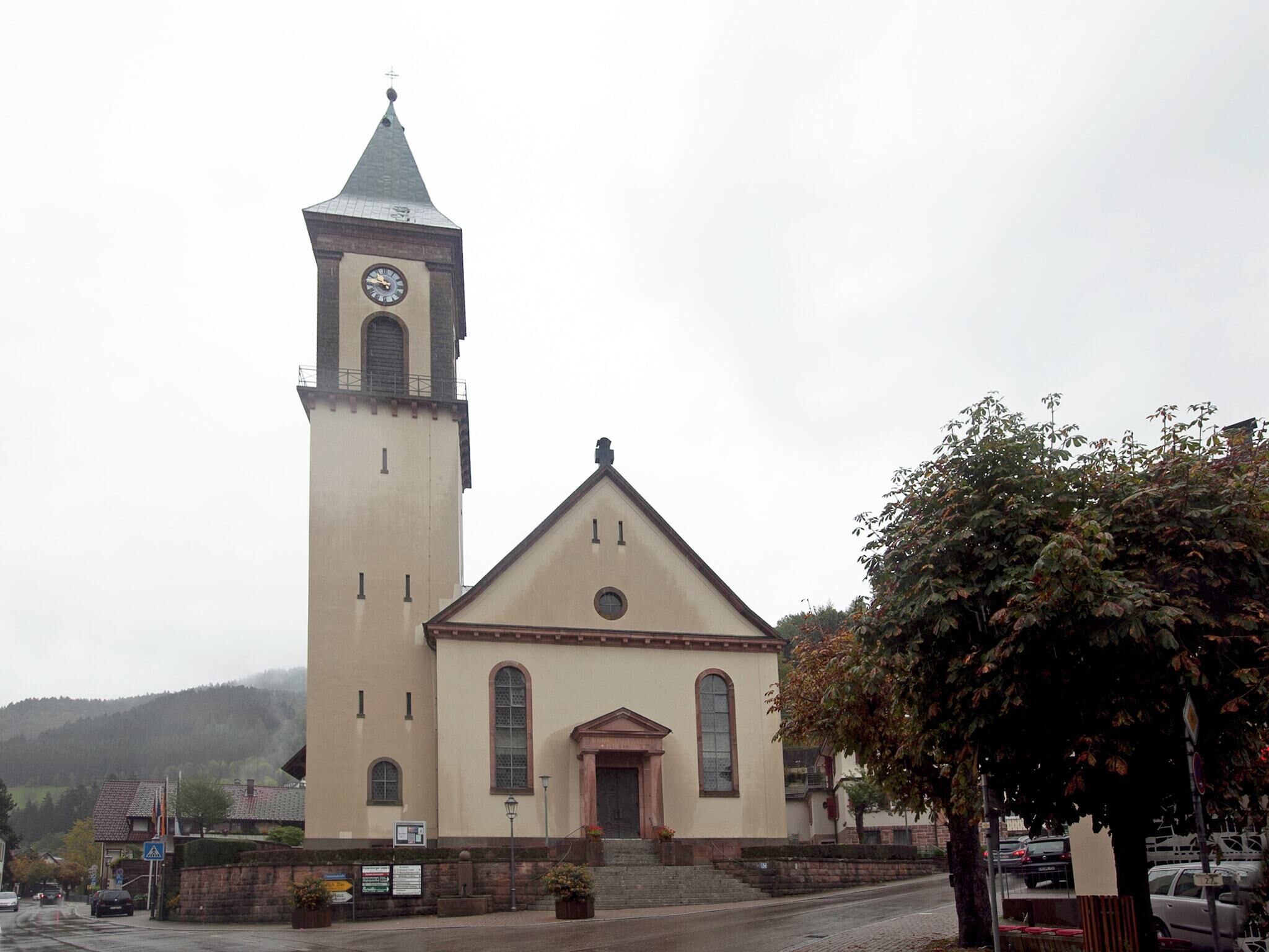A church with a tall bell tower and a smaller main building.