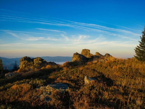 A natural landscape with rocky formations and a clear sky.