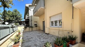 A courtyard with potted plants, a bicycle, and a window with blinds. - The "Cenerone" - Comfort and Relax, discover sea and country, feel our culture (Borgo Santa Maria Immacolata)