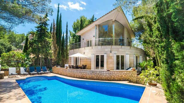 A modern two-story house with a swimming pool, stone walls, and outdoor seating. - Villa in Alcúdia near Sandy Beach (Alcudia)