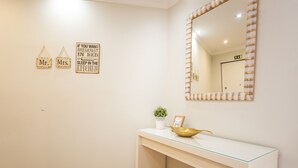 A hotel room with a white console table, a gold bowl, a small potted plant, and two signs on the wall. - Tropical Sun by Atlantic Holiday (Funchal)
