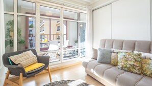 A modern living room with a sofa, a chair, and a large window. - Tropical Sun by Atlantic Holiday (Funchal)