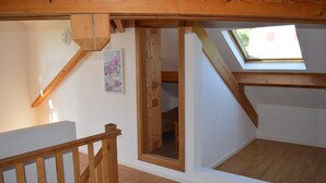 A wooden staircase leading to a loft bedroom with a skylight. - Villa Overlooking Les Vans Centre (Les Vans)