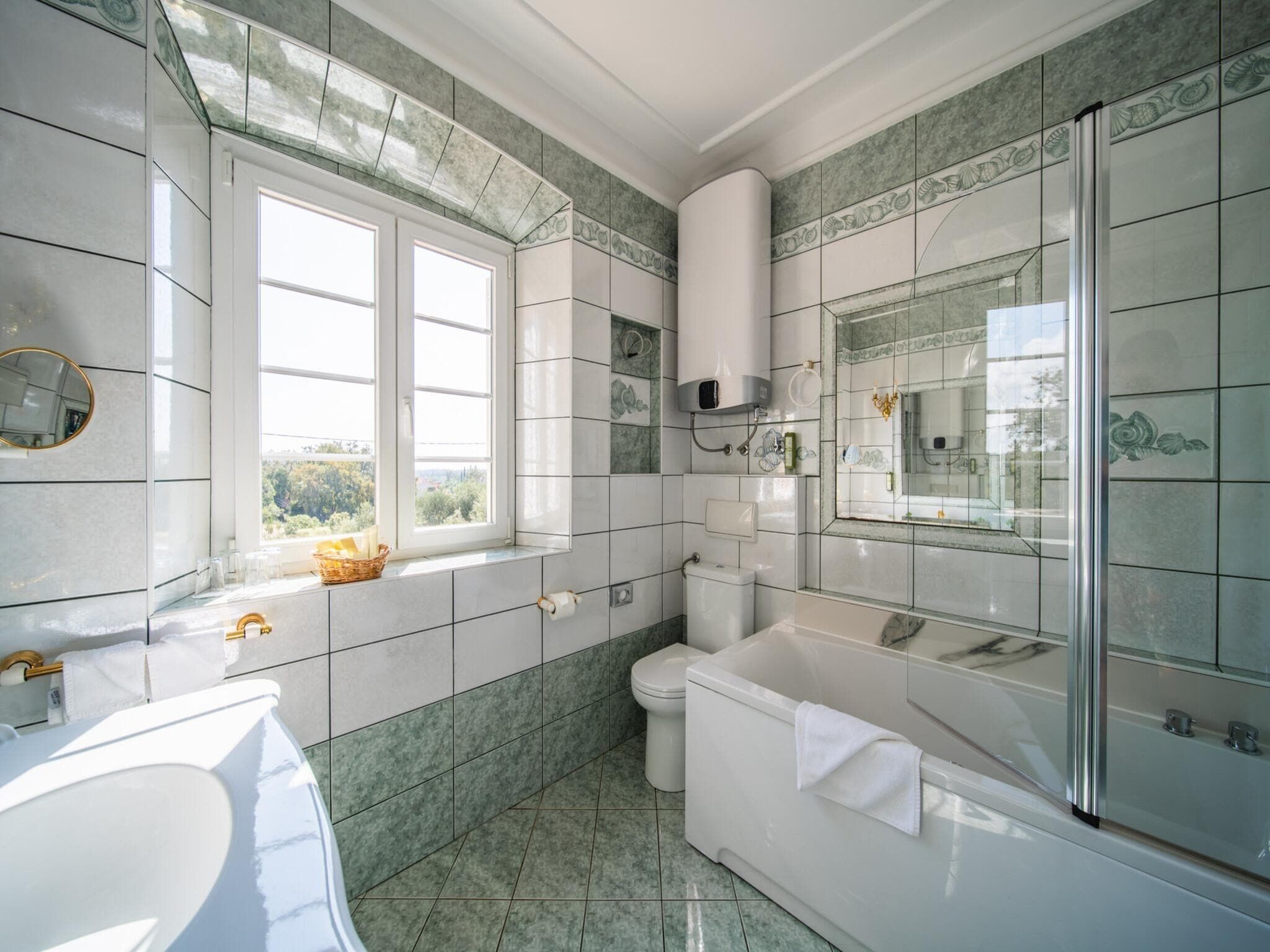 A bathroom with a bathtub, toilet, and sink.