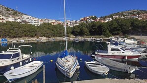 A marina with several boats docked, surrounded by a hillside with buildings. - Apartment in Zadar with free wifi (Zadar)