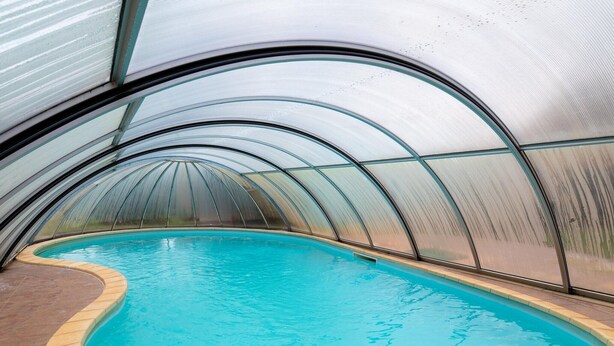 An indoor swimming pool with a curved glass ceiling and a tiled floor. - Spacious Holiday Home in Verteneglio (Brtonigla)