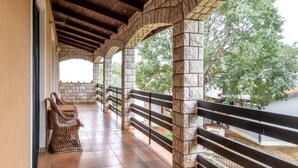 A covered outdoor area with stone pillars, a wooden ceiling, and a tiled floor. - Spacious Holiday Home in Verteneglio (Brtonigla)