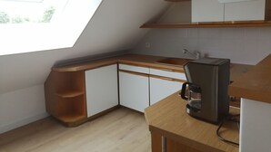 A modern kitchen with a skylight, wooden cabinets, and a coffee maker. - Southern Brittany - peace and quiet by the sea (Noyal-Muzillac)