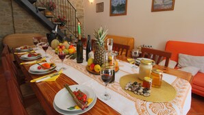 A dining table set with plates, cutlery, and various fruits and beverages. - Mansion in Apecchio near Lake (Apecchio)