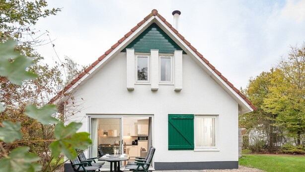 A two-story house with a green roof, white exterior walls, and a visible kitchen area. - Cozy House nr Drents-Friese (Hoogersmilde)