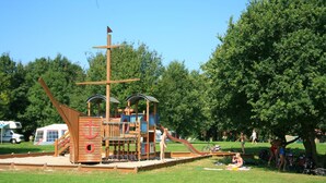 A playground with a ship-themed play structure, including slides and climbing areas. - Cozy House Surrounded by Nature (Tynaarlo)