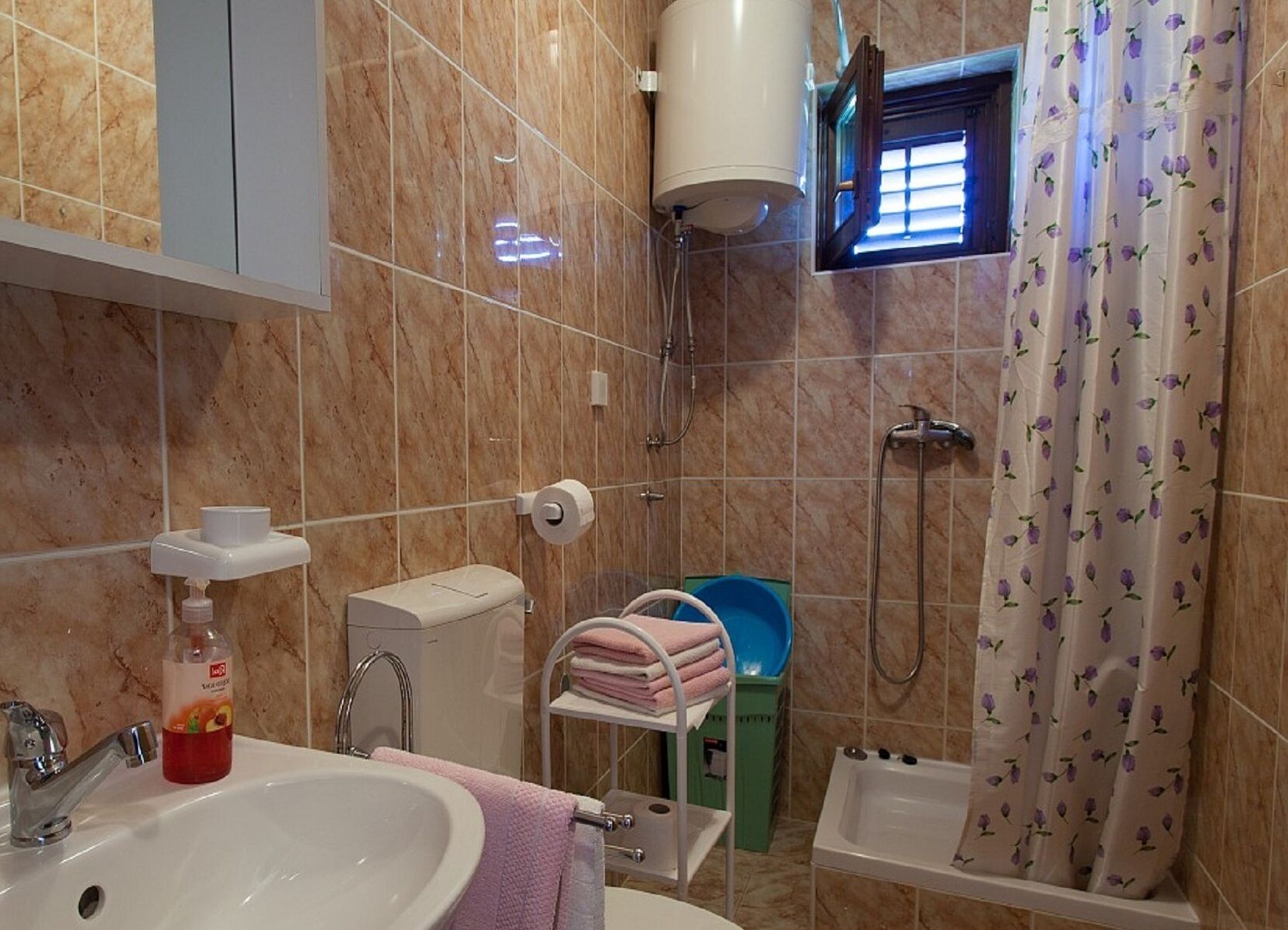 A bathroom with a sink, toilet, shower, and bathtub.