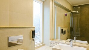 Ein modernes Badezimmer mit Toilette, Waschbecken und Spiegel.