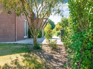 A brick building with a gravel pathway leading to a door. - Holiday Home in Treignes for 9 Person (Treignes)