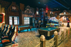 Enjoy a game of pool or billiards in this lively indoor space with a pool table and billiards setup.