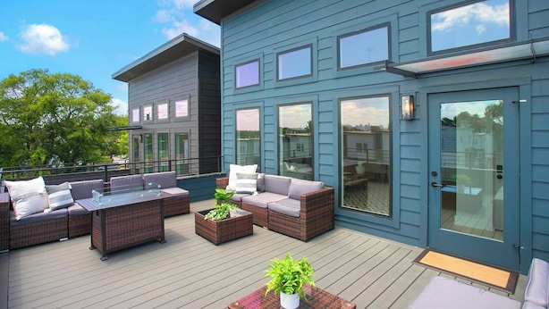 A modern outdoor deck with wicker furniture and glass doors. - 4 BDR Stay for 12 w/Rooftop Patio Firepit! Near DT (Nashville)