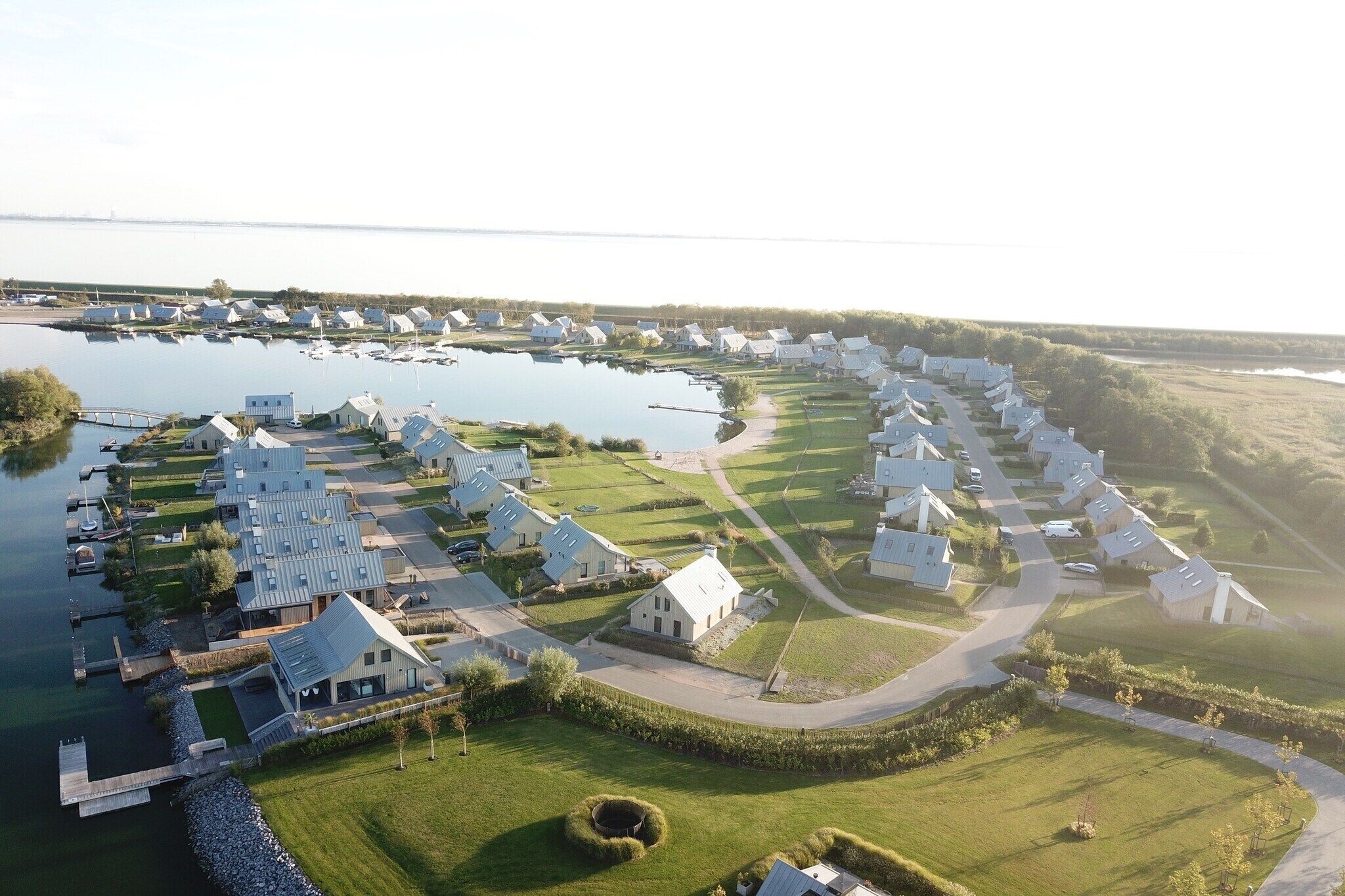 A residential area with houses, a dock, and a body of water.