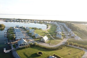 A residential area with houses, a dock, and a body of water.