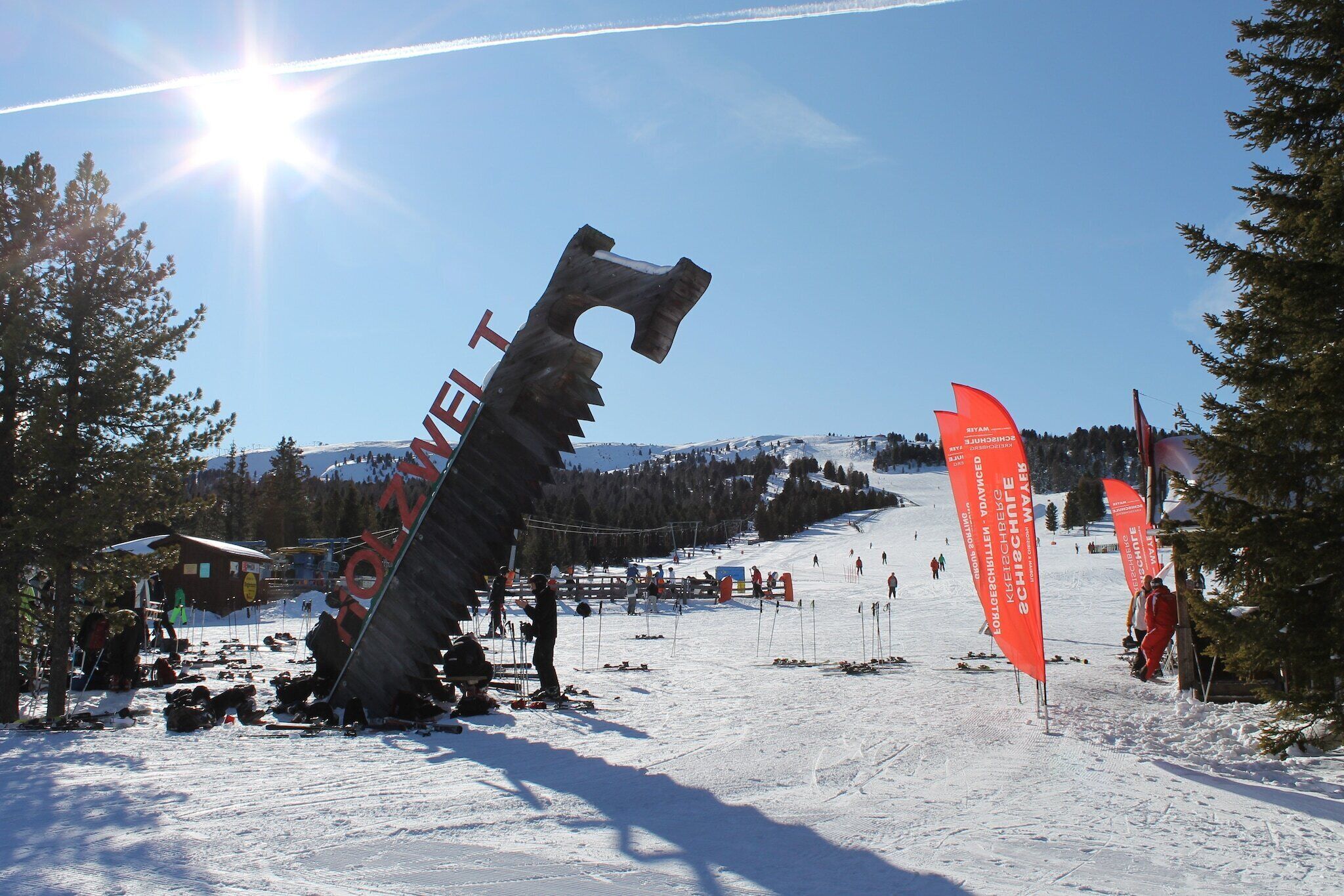 A ski resort with a large ski lift and flags.