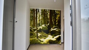 A hallway with a large forest mural on the wall. - Holiday Home in Manhay near Ski Area (Manhay)